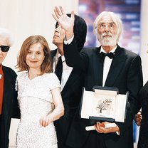 Ο Μίκαελ Χάνεκε κρατά στα χέρια του το Χρυσό Φοίνικα, ενώ ποζάρει δίπλα στην παλιά του γνώριμη από τη 